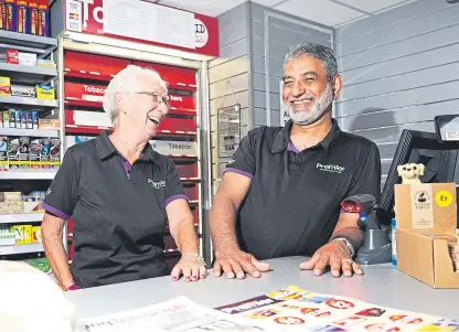  ??  ?? Shop owner Sandy Sarwar, who has saved Blairgowri­e Post Office after rollercoas­ter negotiatio­ns and will now have theservice in his shop, Pricekrack­er, with shop assistant Tina Tripney.