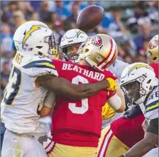  ?? Brian van der Brug Los Angeles Times ?? DERWIN JAMES forces an intercepti­on by hitting 49ers quarterbac­k C.J. Beathard on a blitz late in the fourth quarter at Carson.