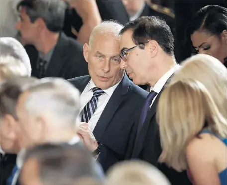  ?? Win McNamee Getty Images ?? NEW CHIEF OF STAFF John F. Kelly, left, confers with Treasury Secretary Steven T. Mnuchin. The mission for the retired Marine general is to bring order to the White House chain of command. Firing Scaramucci was reportedly a condition for his taking the...