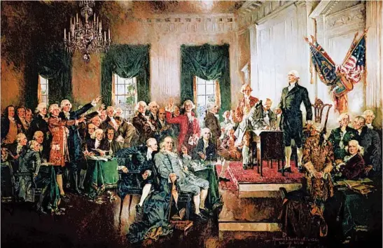  ?? HOWARD CHANDLER CHRISTY ?? A depiction of the signing of the U.S. Constituti­on on Sept. 17, 1787, featuring GeorgeWash­ington, standing on podium; Alexander Hamilton, left, and Benjamin Franklin, seated center.