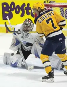  ?? ADRIAN WYLD/THE CANADIAN PRESS ?? Otters left wing Christian Girhiny tries to deflect a shot past Sea Dogs goalie Callum Booth during Memorial Cup semifinal action on Friday.