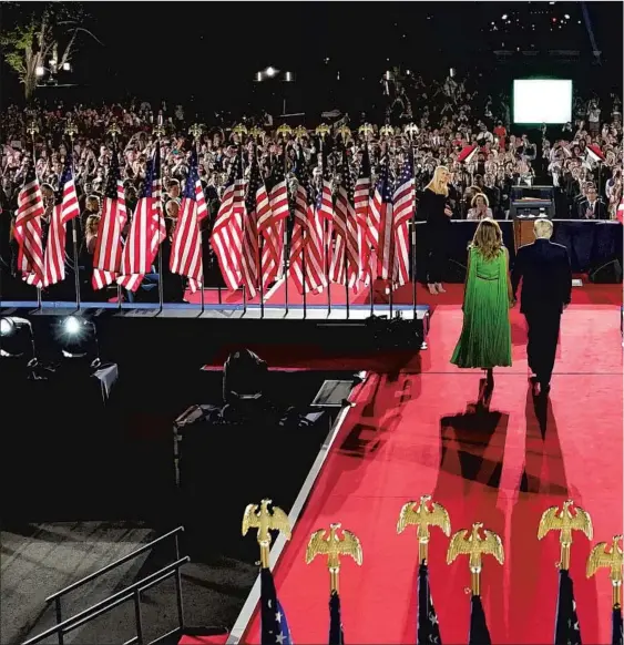  ??  ?? PRESIDENT TRUMP, with First Lady Melania Trump, arrives to deliver his nomination acceptance speech on the White House South Lawn in late August. Had he taken