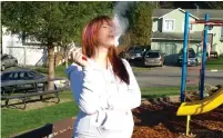  ?? (Screenshot) ?? A PREGNANT WOMAN smokes at the playground, ignoring the danger to her unborn child.