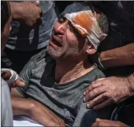  ??  ?? A Palestinia­n survivor mourns his children who were killed