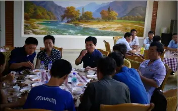  ?? AP PhoTo/DITA AlAngkArA ?? People have their lunch at Pyongyang House of Sweet Meat, a restaurant specialize­d in dishes made of dog meat, in Pyongyang, North Korea, on Wednesday.