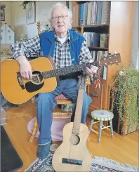  ?? SALLY COLE/THE GUARDIAN ?? Garnet Buell has two favourite guitars. The first is the 1974 Martin D28 that he’s holding. The smaller is one that he received from his mother when he was nine-years-old. It’s a wartime guitar and was built completely of wood because metal wasn’t...