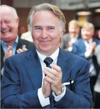  ?? JIM WELLS ?? Ron Mathison applauds during a ceremony at the University of Calgary on Friday, where it was announced the philanthro­pist will gift $20 million to help fund a second building for the Haskayne School of Business.