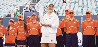  ?? AFP PIC ?? Ashleigh Barty poses with the trophy after defeating Bianca Andreescu in the final of the Miami Open on Saturday.