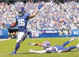  ?? ADAM HUNGER/AP ?? Giants running back Saquon Barkley breaks away for a 27-yard touchdown run Sunday against the Bills.