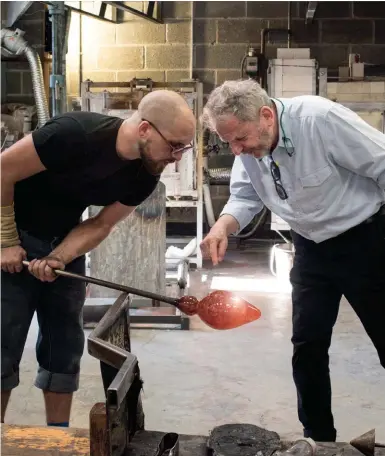  ??  ?? Art of glass: Peter Layton checks a new piece on Elliot Walker’s blowing iron