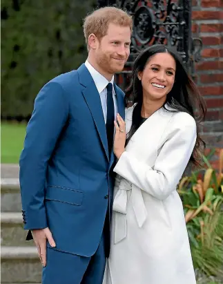  ?? PHOTO: REUTERS ?? Prince Harry poses with Meghan Markle in the Sunken Garden of Kensington Palace in London after the couple announced their engagement.