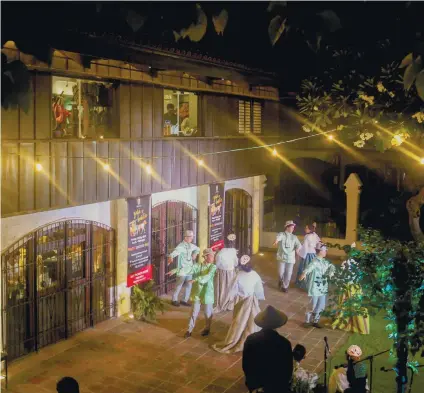  ??  ?? Dancers in period-correct clothes perform on the patio outside the cafe and gift shop of the renovated Casa Gorordo Museum in the Parian district, which offered various attraction­s, including “trick photograph­y.”