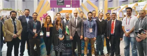  ??  ?? BARCELONA: Zain Group’s Vice Chairman Bader Al-Kharafi (center) is seen with young Kuwaiti entreprene­urs at Zain’s dedicated booth at the 4YFN Startup Conference at the 2017 Mobile World Congress (MWC).