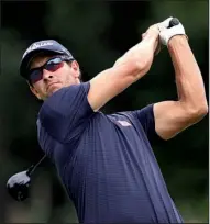  ?? AP/ADAM HUNGER ?? Adam Scott, teeing off Friday on the fifth hole at The Barclays, took advantage of a 6-under-par 65 to move into a tie for first with Cameron Tringale after two rounds.