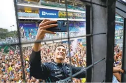  ?? MARCELO CHELLO AP ?? Mercedes driver George Russell takes a selfie after winning in Brazil.