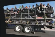  ?? Marco Ugarte / Associated Press ?? Central American migrants ride on a truck in Celaya, Mexico, on their way to the U.S. border.