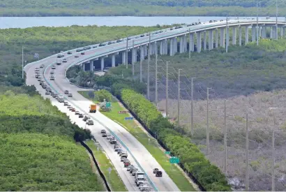  ?? ALAN DIAZ/AP ?? Motorists head north on U.S. 1 through Key Largo, Florida, on Wednesday, trying to get out of the way of the approachin­g hurricane, Irma.