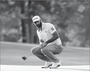  ?? DUSTIN JOHNSON, Matt Slocum Associated Press ?? looking to add a Masters to his 2016 U.S. Open title, misses a birdie putt on the 17th green. Johnson was four under for his round after four holes Saturday and never looked back.