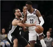  ?? FRANK FRANKLIN II — THE ASSOCIATED PRESS ?? San Antonio’s Derrick White, left, defends Brooklyn’s Caris LeVert during the first half of Friday’s game.