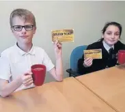  ??  ?? Over and above Pupils Kai and Bethany receive a golden ticket to enjoy a hot choc