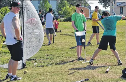  ?? ERIC MCCARTHY/JOURNAL PIONEER ?? Athletes trying out for the national junior men’s softball team participat­e in a batting drill Tuesday morning in O’Leary.