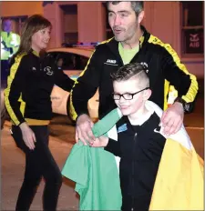  ??  ?? Shane Haran arriving to his homecoming with Paul Walsh, South Sligo AC.