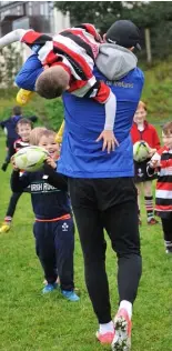  ??  ?? Tadhg Hannefy is ‘unfairly’ challenged by Rob Kearney during his and Dave’s visit to the Carlingfor­d Knights training session.