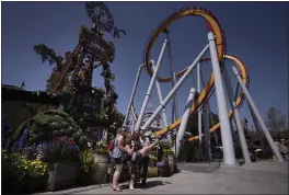  ?? JAE C. HONG — THE ASSOCIATED PRESS ?? Visitors revel during the Knott’s Taste of Boysenberr­y Festival at Knott’s Berry Farm in Buena Park on Tuesday.