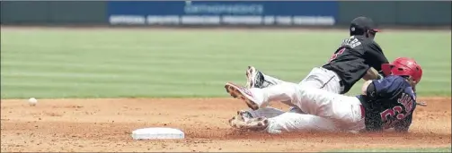  ?? PHOTOS BY DALE L. ANDERSON/SPECIAL TO THE COMMERCIAL APPEAL ?? Memphis base runner Ryan Jackson slides toward safety as Albuquerqu­e second baseman Elian Herrera lunges for an errant throw during the Isotopes’ 5-3 win Sunday over the Redbirds. The Redbirds trailed 5-1 heading into the bottom of the ninth, but they...