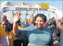  ?? CURTIS COMPTON/ATLANTA JOURNAL-CONSTITUTI­ON ?? Former Democratic candidate for Georgia governor Stacey Abrams crosses the Edmund Pettus Bridge in Selma, Alabama, during the city’s reenactmen­t of Bloody Sunday on March 1 last year.