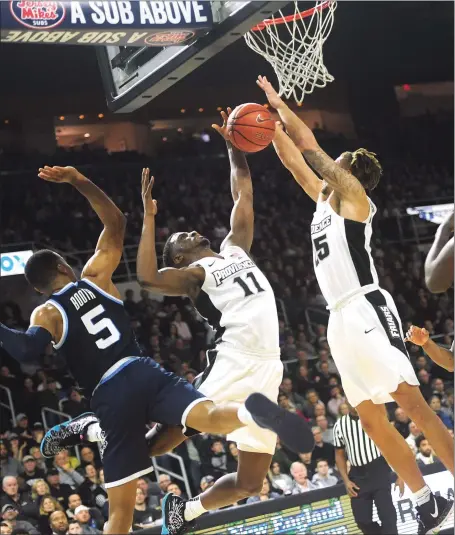  ?? Photo by Ernest A. Brown ?? Providence College’s Alpha Diallo (11) and Drew Edwards (25) battle Villanova’s Phil Booth for a rebound during Saturday afternoon’s Big East clash at the Dunkin’ Donuts Center. The Friars’ second-half comeback came up short in a 65-59 loss to the defending national champions.