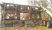  ??  ?? A replica courthouse nears completion at the Chattanoog­a Woodworkin­g Academy on Market Street.
Academy students work on a log home.