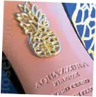  ??  ?? Statement heels: Lily James and (inset) shoemaker Aquazzura’s pineapple logo