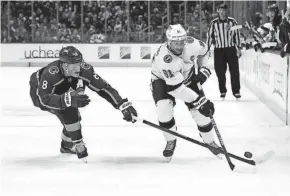  ?? RON CHENOY/USA TODAY SPORTS ?? Colorado Avalanche defenseman Cale Makar (8) pokes the puck away from Tampa Bay Lightning center Steven Stamkos (91) during a regular season game.