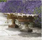  ??  ?? Flanking steps or a doorway, a pair of planters add a note of symmetry: 19th- century French cast-iron garden urns, £ 580 FAR RIGHT A decorative sundial is a romantic feature in any garden, £ 2,600, all Lichen Garden Antiques