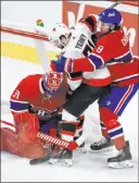  ?? Ryan Remiorz The Associated Press ?? Montreal goaltender Carey Price stops Ottawa Senators center Chris Tierney as Canadiens’ Ben Chiarot defends during the third period Tuesday in Montreal.