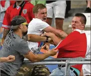  ?? THANASSIS STAVRAKIS / ASSOCIATED PRESS ?? Russian supporters attack an England fan during a brawl at the end of their Euro 2016 Group B soccer match in 2016.