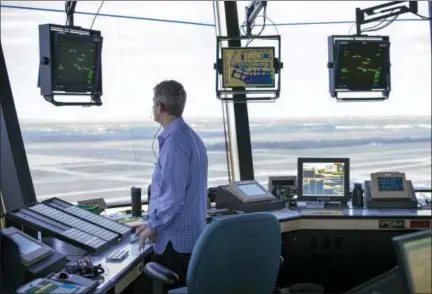  ?? CLIFF OWEN — THE ASSOCIATED PRESS FILE ?? In this file photo, a FAA Air Traffic Controller works in the Dulles Internatio­nal Airport Air Traffic Control Tower in Sterling, Va. President Donald Trump is calling for privatizin­g the nation’s air traffic control operations in his budget proposal,...