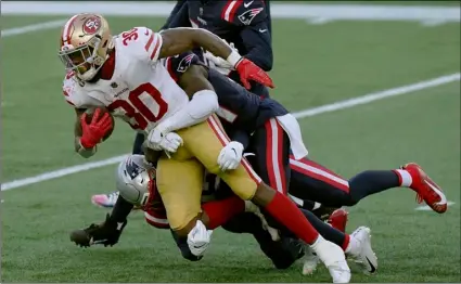  ?? AP Photo/Steven Senne ?? San Francisco 49ers running back Jeff Wilson Jr. gains yardage against the New England Patriots in the first half of an NFL football game, on Sunday in Foxborough, Mass.