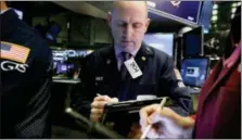  ?? RICHARD DREW — THE ASSOCIATED PRESS FILE ?? Trader Michael Urkonis works on the floor of the New York Stock Exchange.