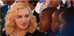  ??  ?? In this file photo, Madonna, left, sits with her adopted children David, Stella and Mercy, at the opening of The Mercy James Institute for Pediatric Surgery and Intensive Care.