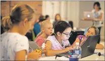  ?? CP FILE PHOTO ?? Students attend a Girls Learning Code computer workshop in Toronto in July 2014.