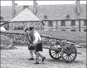  ?? FILE PHOTO ?? Soldiers in period dress haul wood at Fortress Louisbourg in this file photo.