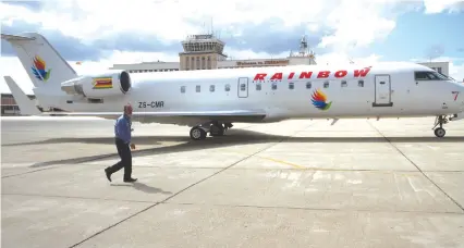  ??  ?? Rainbow Airlines CEO ED Berry walks across the tarmac to the airline’s 50-seater Bombadier CRJ100 aircraft which arrived in the country yesterday. The new airline will make its first commercial flight to Victoria Falls today with tickets pegged at $100...