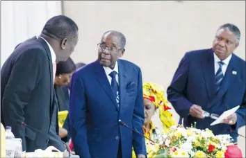  ?? - (Picture by Justin Mutenda) ?? President Mugabe converses with Vice President Emmerson Mnangagwa, while First Lady Amai Grace Mugabe and Vice President Phelekezel­a Mphoko (right) look on.