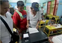  ?? AP file ?? A man enters the first vote of his precinct at a school used as a voting centre during mid-term elections in Manila in 2013. —