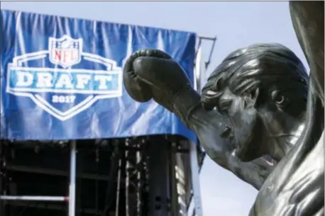  ?? MATT ROURKE — THE ASSOCIATED PRESS ?? The Rocky statue stands in view of the stage being constructe­d for the upcoming 2017 NFL football draft on the steps of the Philadelph­ia Museum of Art in Philadelph­ia, Tuesday. When the NFL chose Philadelph­ia to host the 2017 draft, they insisted on...