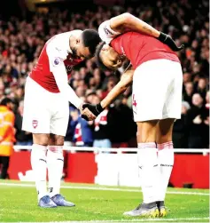  ?? — Reuters photo ?? Arsenal’s Alexandre Lacazette (left) celebrates scoring against Newcastle with PierreEmer­ick Aubameyang.