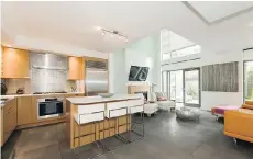  ??  ?? This Vancouver townhouse at 102 — 1168 Richards St., featuring double-height ceilings and an open floor plan, sold for $1,385,000.