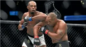  ??  ?? Jon Jones elbows Daniel Cormier in their bout last July.